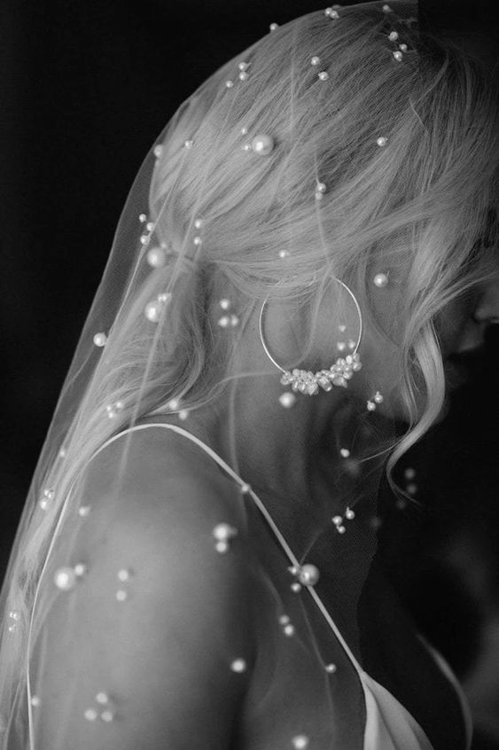 a pearl embellished veil with pearls of different size is a fresh take on wearing pearls by a bride