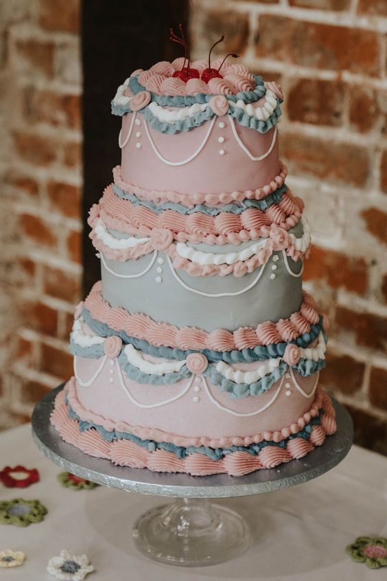 a pink and blue wedding cake with plenty of sugar detailing and cherries on top is a lovely idea for a pastel wedding