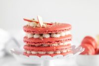 a pink apple macaron cake with vanilla cream and apple slices on top is a lovely idea for a fall wedding