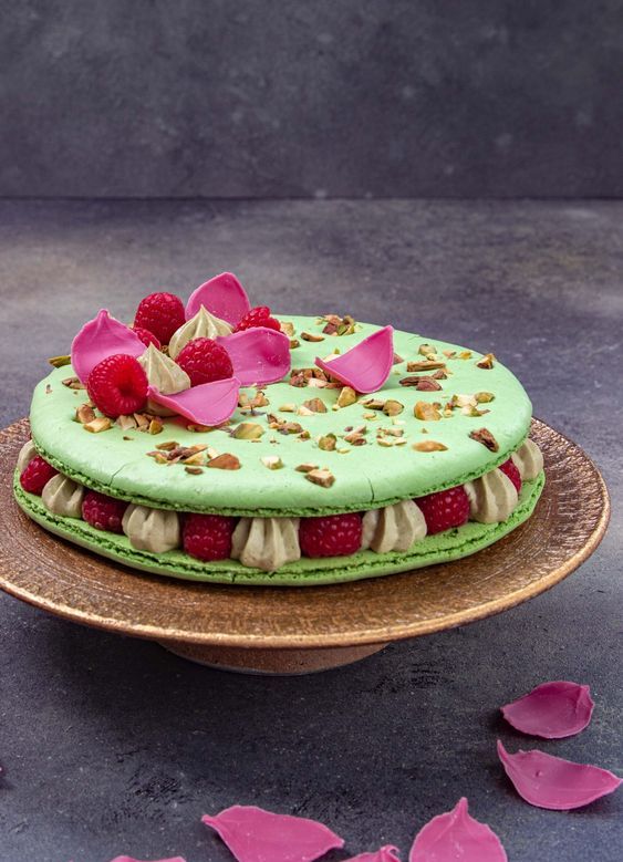 a pistachio cake with fresh raspberries, with petals, meringues, raspberries and nuts on top is a very sophisticated idea