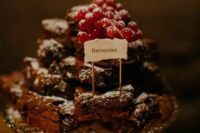a pretty brownie stack topped with fresh berries and with a little sign is a cool idea for a casual wedding