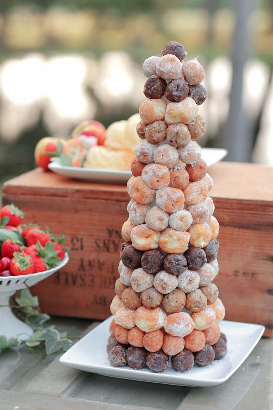 a pretty croquembocueh of usual and chocolate pieces plus iced ones is a lovely idea for a summer wedding