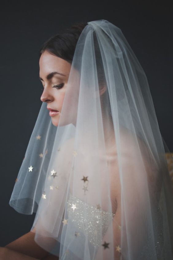 a sheer veil embellished with gold stars will be a great addition to a modern and glam celestial bridal look