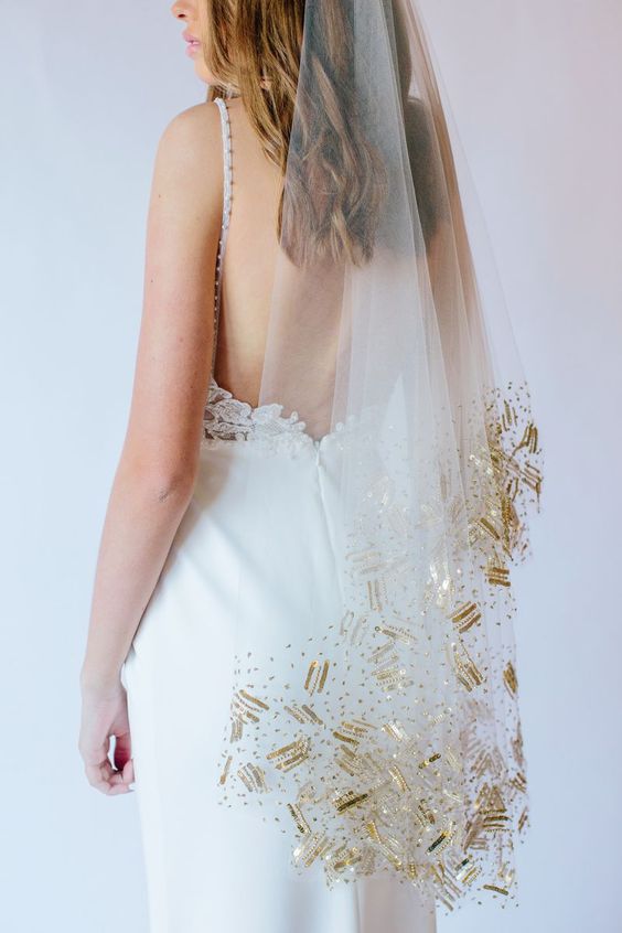 a sheer veil with gold crystals and sequins covering the edge is a super chic and glam idea for a modern bride
