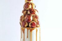 a small and stylish wedding cake – a tall real cake topped with a croquembouche and caramel is amazing