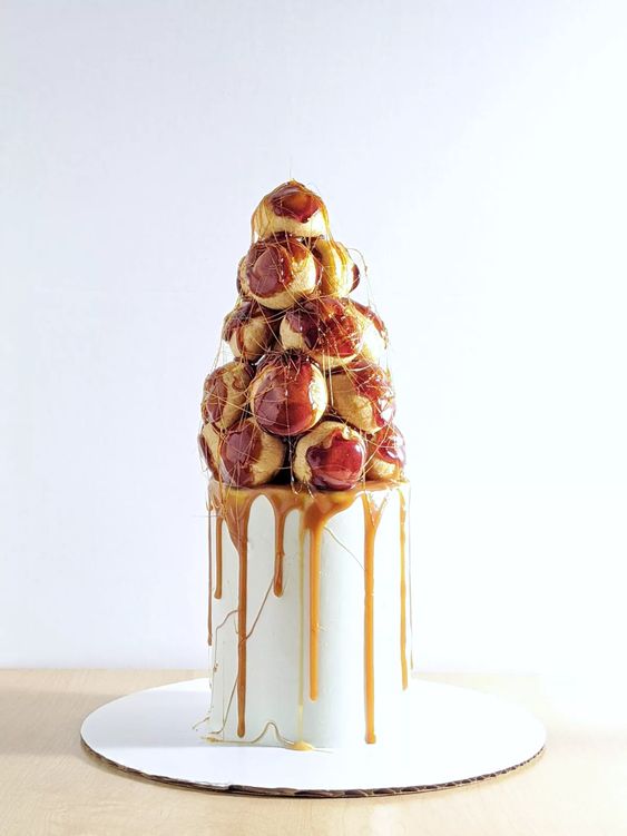 a small and stylish wedding cake - a tall real cake topped with a croquembouche and caramel is amazing