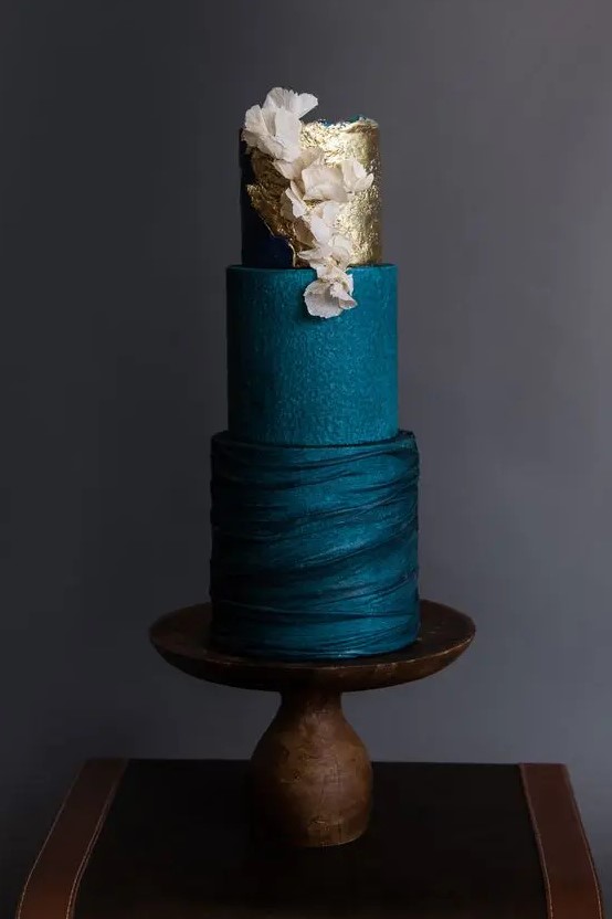 a sophisticated teal wedding cake with textural tiers, gold leaf and blush blooms is a very chic and very stylish idea for a modern wedding