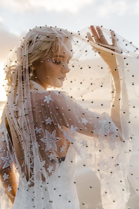 a star embroidered and black pearl embellished wedding veil is amazing for a celestial boho bride
