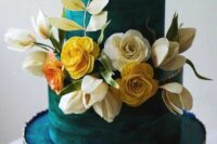 a teal wedding cake with a gold edge, with neutral, blush and yellow blooms and sugar leaves is a catchy and lovely idea for a wedding