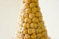 a traditional croquembouche with caramel cover is a spectacular alternative to a usual cake