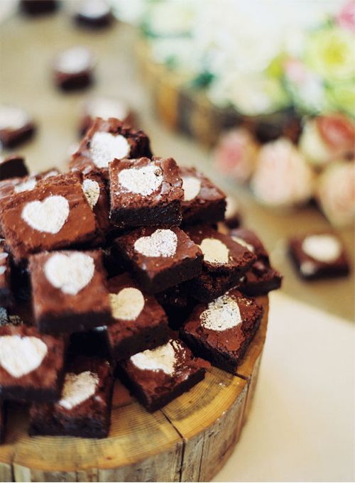 a tree slice with a stack of brownies with little hearts is a lovely idea for a rustic wedding, it can be DIYed