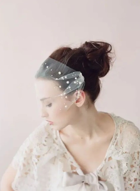 a tulle bandeau veil adorned with large pearls for a cool and modern take on traditional pearls