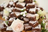 an airy and chic brownie stack decorated with neutral blooms is a lovely idea for a spring or summer wedding