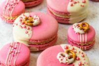 large and small pink and white macarons topped with edible beads and pretzels are adorable as an alternative to a wedding cake