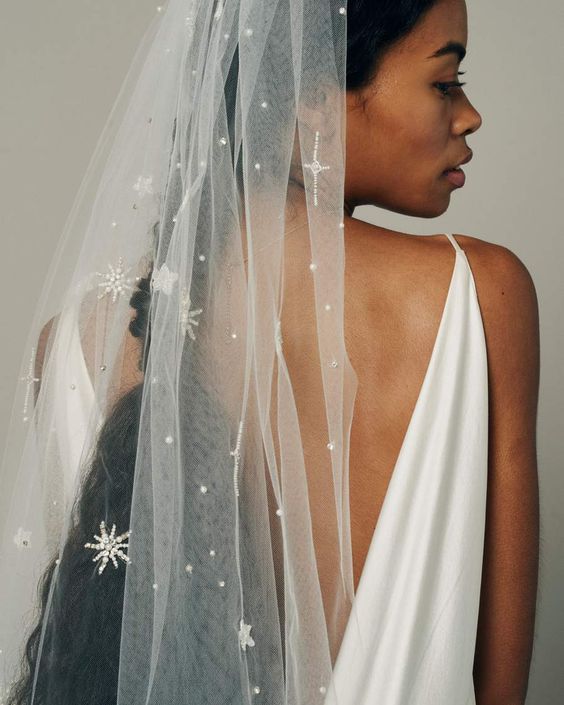 scattered multi sized stars beaded with crystals and pearls on a soft fingertip veil for a celestial bride