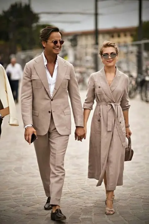 a beige suit, a white shirt, black loafers for a couple look at an informal wedding