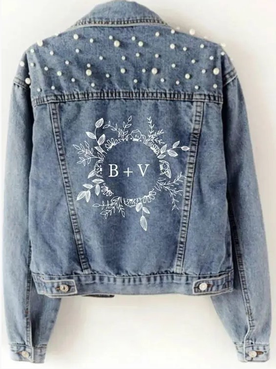 a blue denim jacket with hand painting and pearls over the shoulders is a cool idea for a glam boho bride