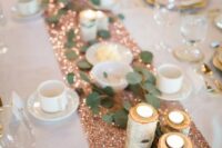 03 a copper sequin wedding table runner with tealights in logs and greenery is a very glam idea
