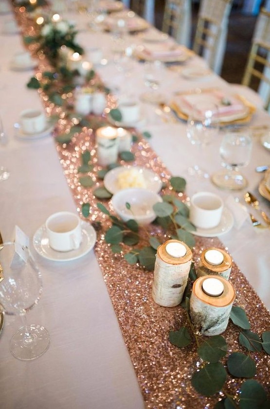 a copper sequin wedding table runner with tealights in logs and greenery is a very glam idea