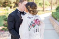 05 a white denim jacket with bold painted blooms and greenery, black calligraphy and black patterns for a modern bride