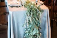 06 a greenery and foliage table runner in pale shades looks organic with a dusty blue tablecloth
