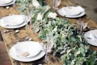 07 a lush and textural greenery table runner with berries is a chic idea for a winter tablescape