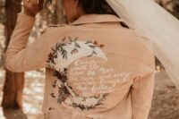 08 a pink leather jacket with a painted half moon, blooms and greenery and a quote is a lovely idea for a romantic bride