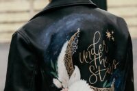 09 a black leather jacket with a night sky, a large half moon, blooms and gold calligraphy is a catchy and lovely idea