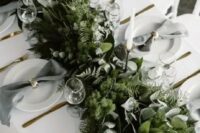 09 a lush woodland-inspired greenery table garland with various kinds of eucalyptus, moss and ferns