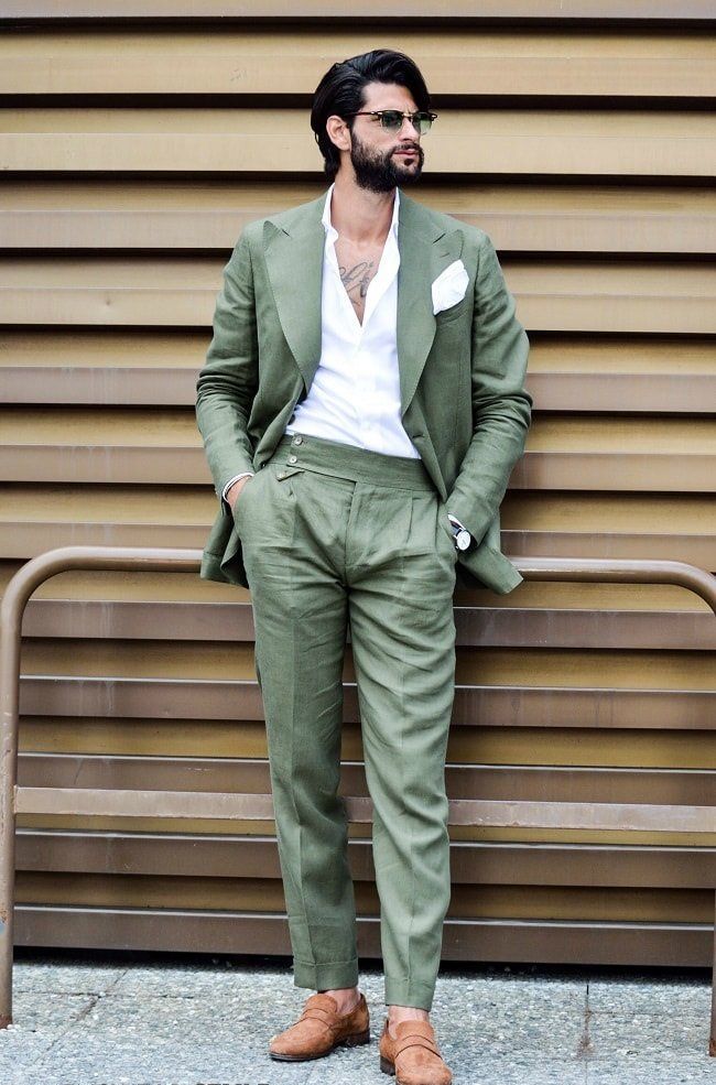 a green pantsuit, a white shirt and brown shoes plus green sunglasses are a fresh spring wedding guest outfit
