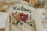 10 a white leather jacket with bright hand painted blooms and greenery, black patterns and a new second namde for a boho bride
