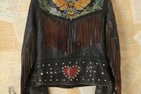 11 a black leather jacket with a painted bee, some leaves, studs, fringe and a heart is a unique solution for a boho bride