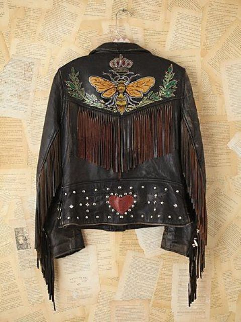 a black leather jacket with a painted bee, some leaves, studs, fringe and a heart is a unique solution for a boho bride