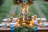 13 a rustic evergreen table runner with berries and pinecones and lots of candles bring winter spirit