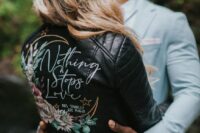 15 a black leather jacket with a painted half moon, bright blooms and calligraphy is a stylish and catchy idea for a boho bride
