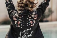 23 a black leather jacket with hand painted blooms, studs and white calligraphy is a bold and catchy cover up to rock
