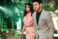 24 Nick Jonas wearing a dove grey suit and a black shirt looks perfect – steal this simple and elegant outfit for attending a wedding