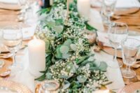 24 a beautiful and delicate greenery table runner with baby’s breath is a lovely idea for a modern wedding, dot it with pillar candles