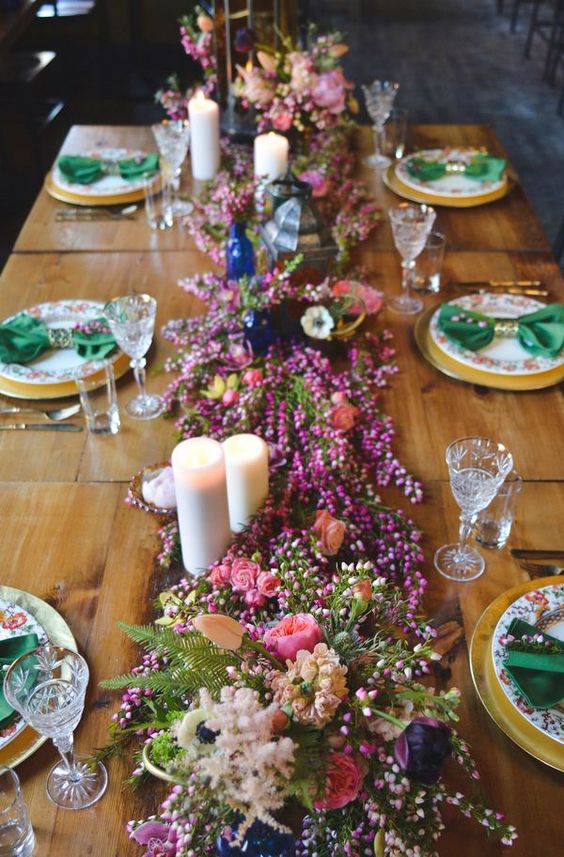 a bright blooming wedding table garland in pink, blush, fuchsia and some greenery is a cool idea for a summer wedding