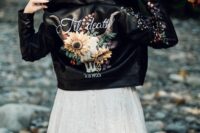 27 a black leather jacket with painted blooms on the back and sleeves and white calligraphy is a cool and catchy idea