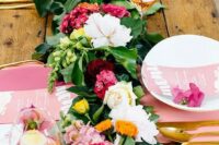 28 a colorful and lush tropical table runner of greenery and white, pink and burgundy blooms for a vibrant touch