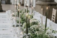 32 a lush and beautiful greenery table runner with white blooms and black and white candles is a chic idea for a spring or summer celebration
