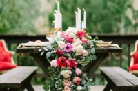 35 a lush greenery and pink and red flower table runner with candles for a refined tablescape