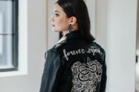 37 a black leather jacket with white calligraphy and white hand painting is a stylish idea for a modern and edgy bride