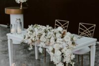 39 a sophisticated white flower table garland will make your tablescape look spectacular and will bring that wow effect to it