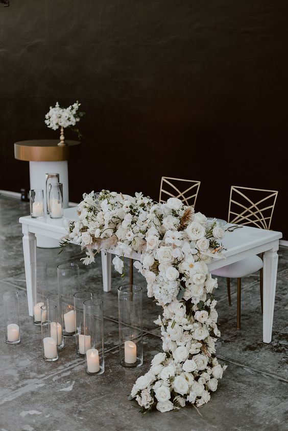 a sophisticated white flower table garland will make your tablescape look spectacular and will bring that wow effect to it