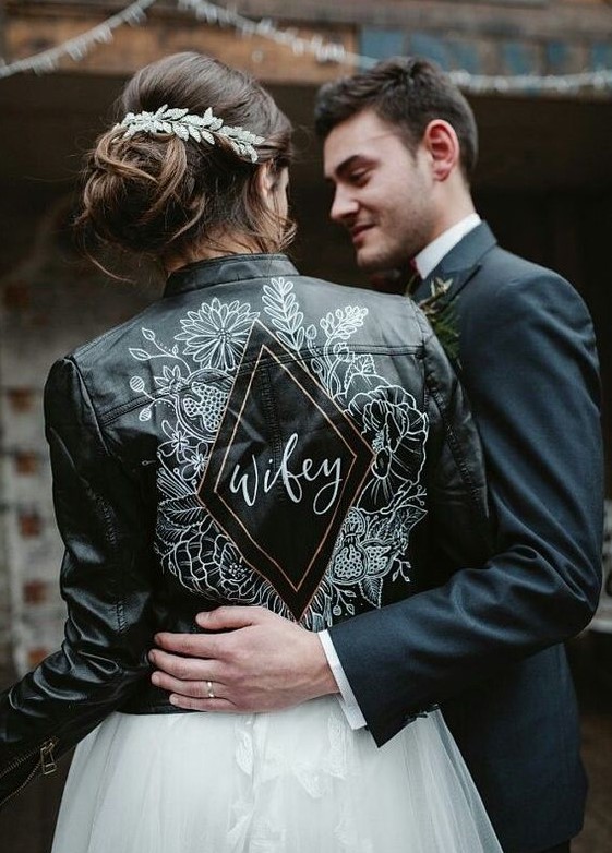 a beautiful black leather jacket with handpainting is a bold and edgy idea for a modern bride