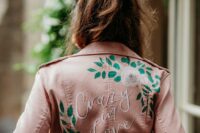 41 a pink leather jacket with painted  blooms and leaves, with white calligraphy is a stylish idea for a modern bride