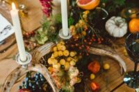 48 a bold woodland table garland with greenery, berries and fruit, antlers and candles plus some bold flowers is amazing for the fall
