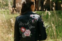 48 a custom black leather jacket with white calligraphy and bright painted blooms is a stylish idea for a bride